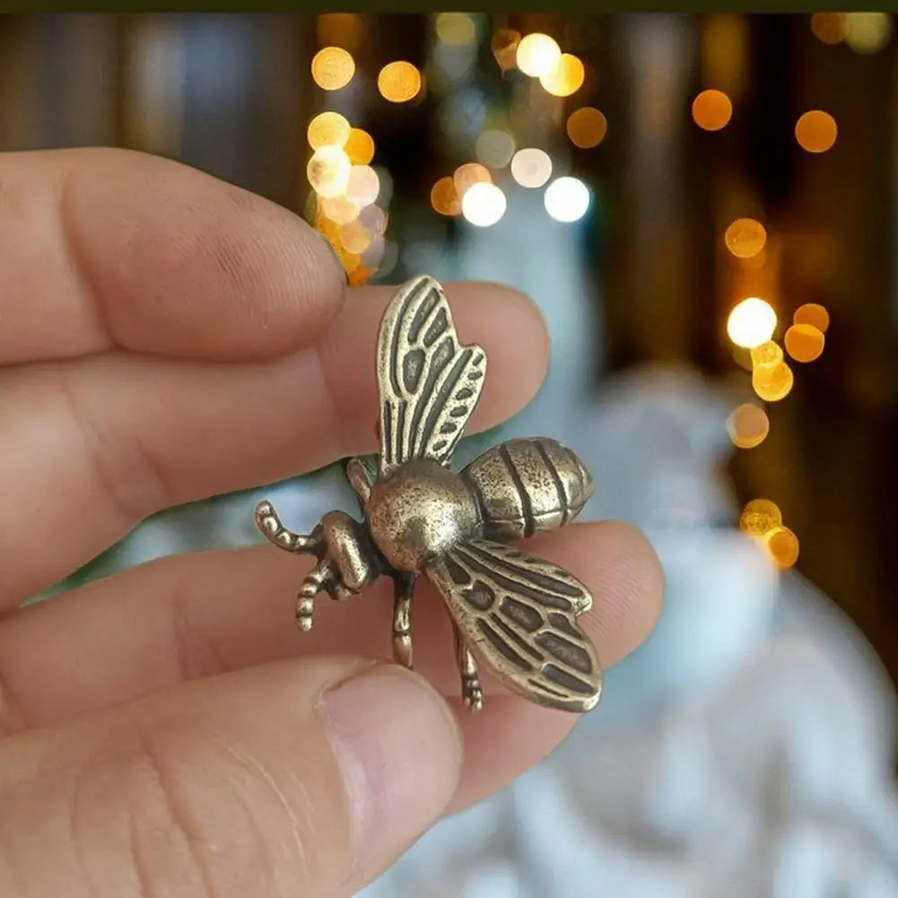 Small solid brass bee figurine, a detailed golden metal tea pet sculpture for unique desktop decoration or gifting.