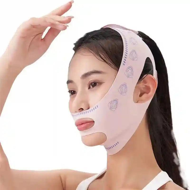 Woman wearing a light pink V-line face sculpting bandage with a purple fan pattern print over her chin and cheeks.