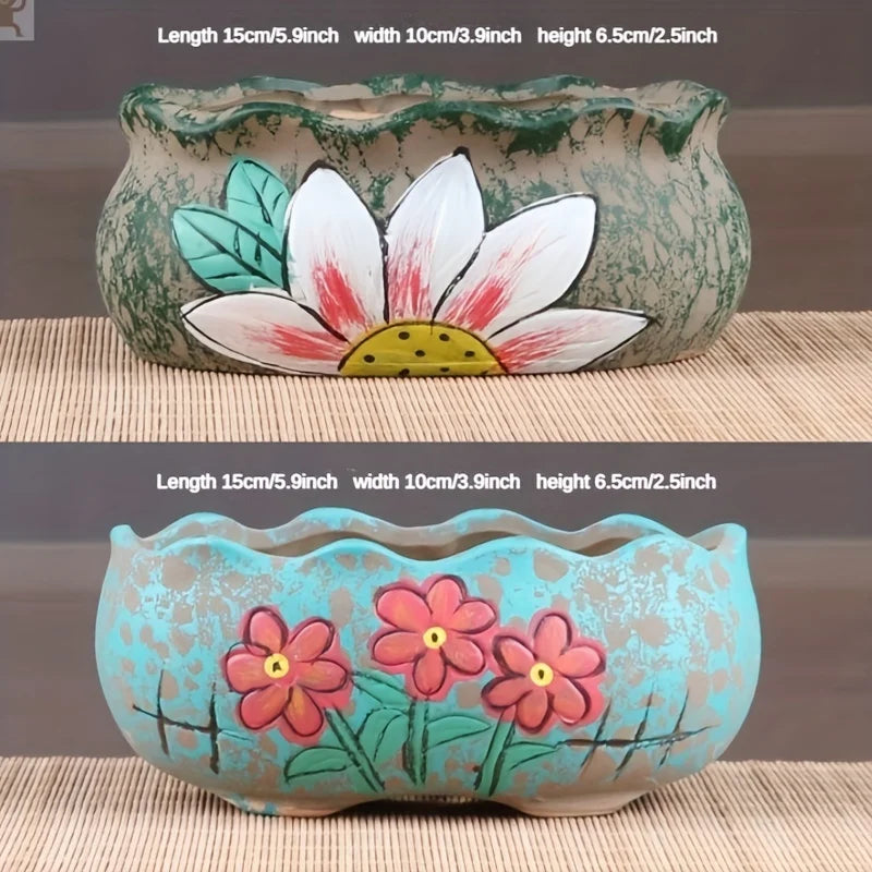 Ceramic oval flower planters, turquoise and speckled green, each with painted blossoms