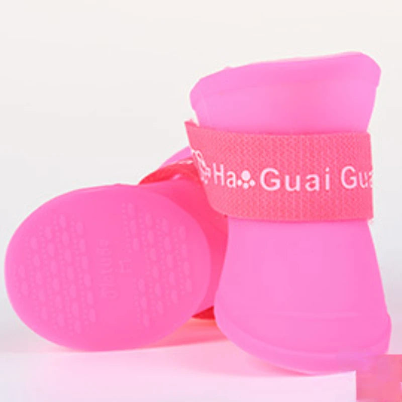 Pink waterproof non-slip dog rain boots with secure straps for comfortable outdoor paw protection and traction.