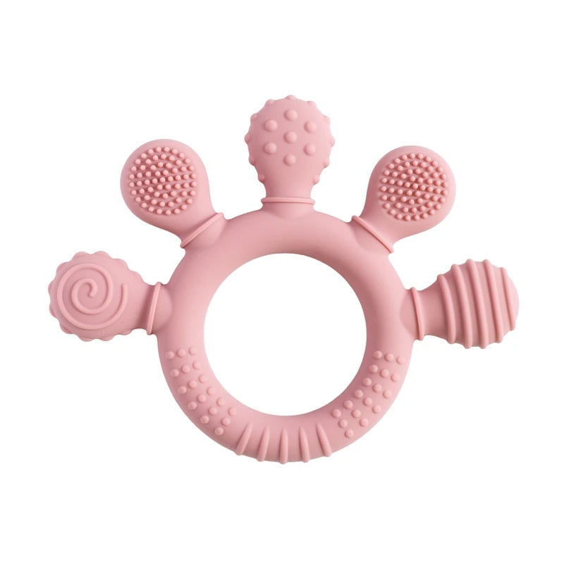Pink silicone teething ring for baby teething relief with textured sensory surfaces.