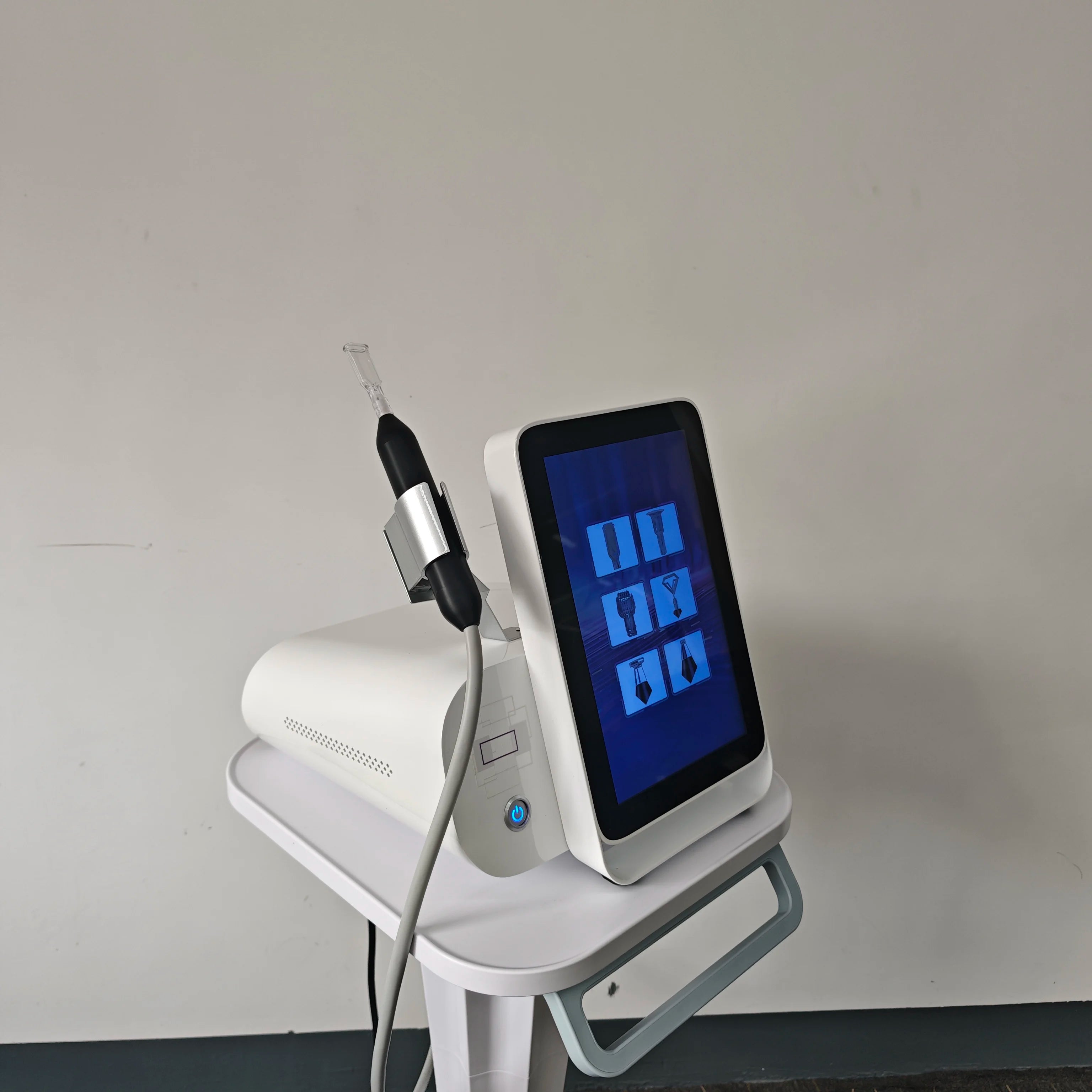 White cold plasma skin repair machine with touchscreen, handpiece, and stand for professional anti-aging and acne care.