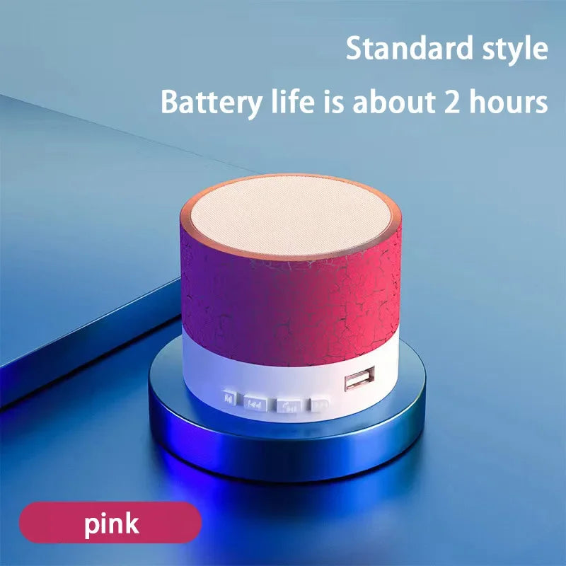 Portable Bluetooth mini speaker, pink cylindrical body with LED light ring and buttons