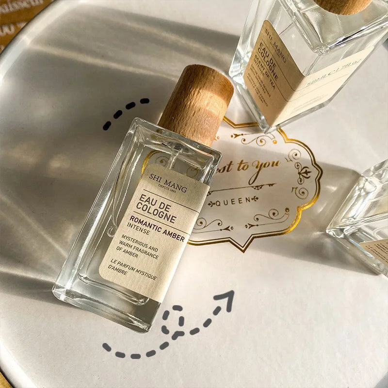 Shi Mang Romantic Amber EDP 50ml: Woody, fruity, tea scented perfume in a chic rectangular bottle with wooden cap.