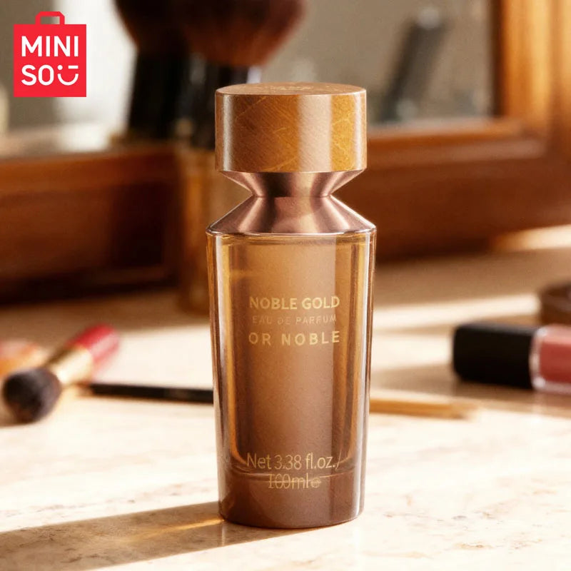 MINISO Noble Gold woody Eau de Parfum for men. 100ml luxury designer fragrance in a sleek brown glass bottle.