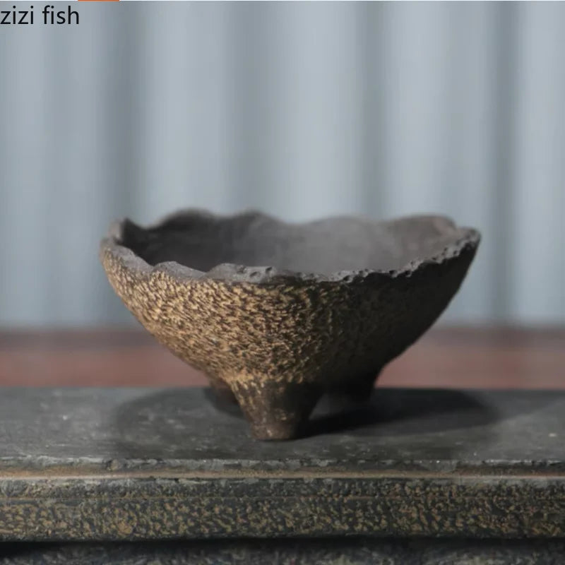 Textured ceramic planter bowl with dark inner cavity and speckled beige outer texture
