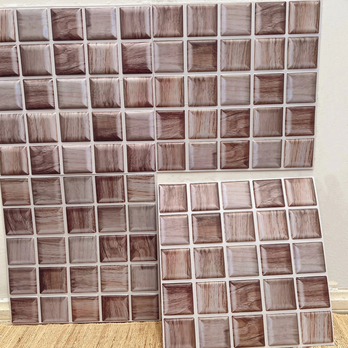 Wood-grain square peel-and-stick backsplash tiles in taupe, gray, and brown tones (12 in x 12 in).