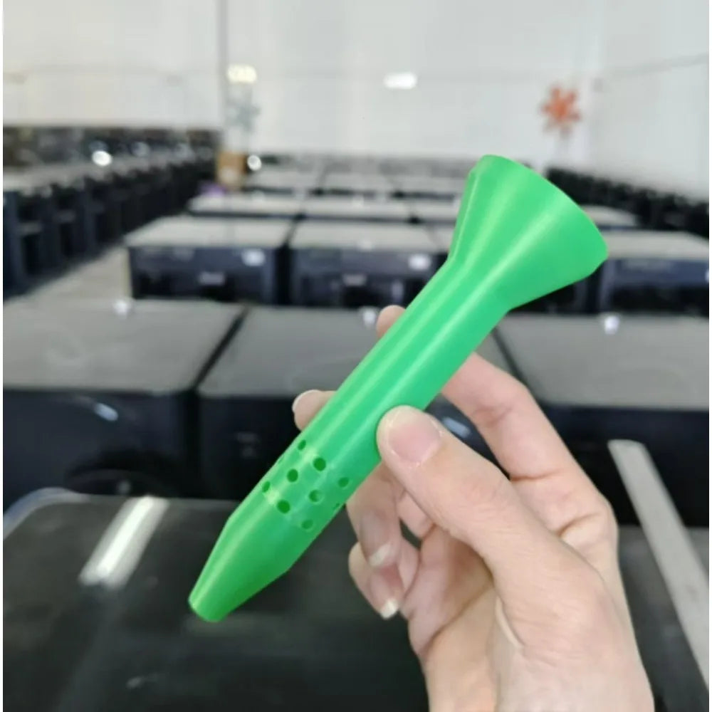 Green gardening irrigation funnel tool held in hand, pointed tip with drainage holes