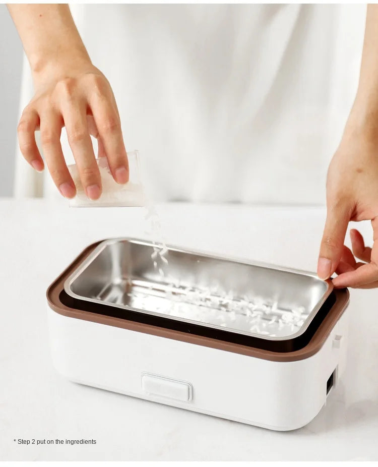 Portable electric heating lunch box with open stainless inner tray and brown rim