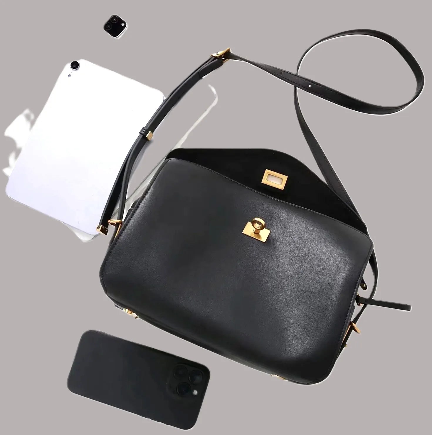 Royaa black genuine leather shoulder bag with gold turn-lock closure, adjustable strap, and elegant classic design.