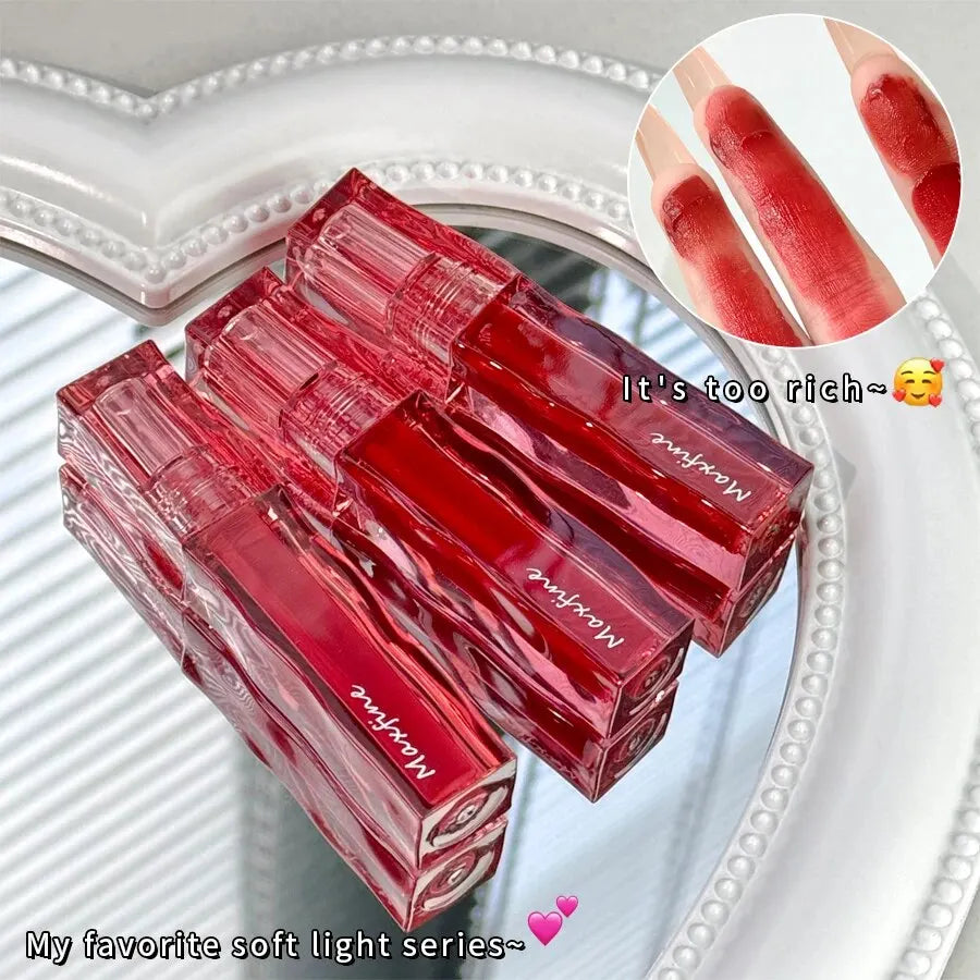 Red liquid lipstick glaze in square tubes with highly pigmented, moisturizing, waterproof, non-stick lip makeup texture.