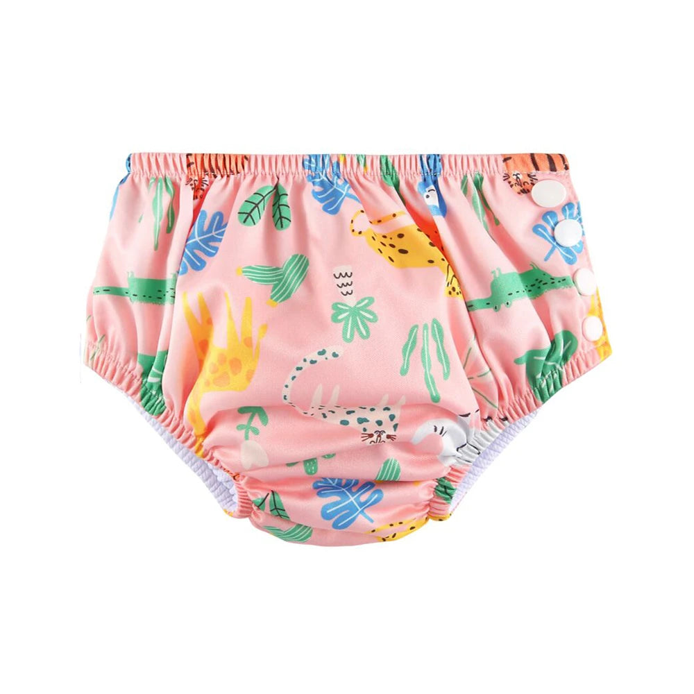 Reusable baby swim diaper in pink with jungle animal print and side snap closures.