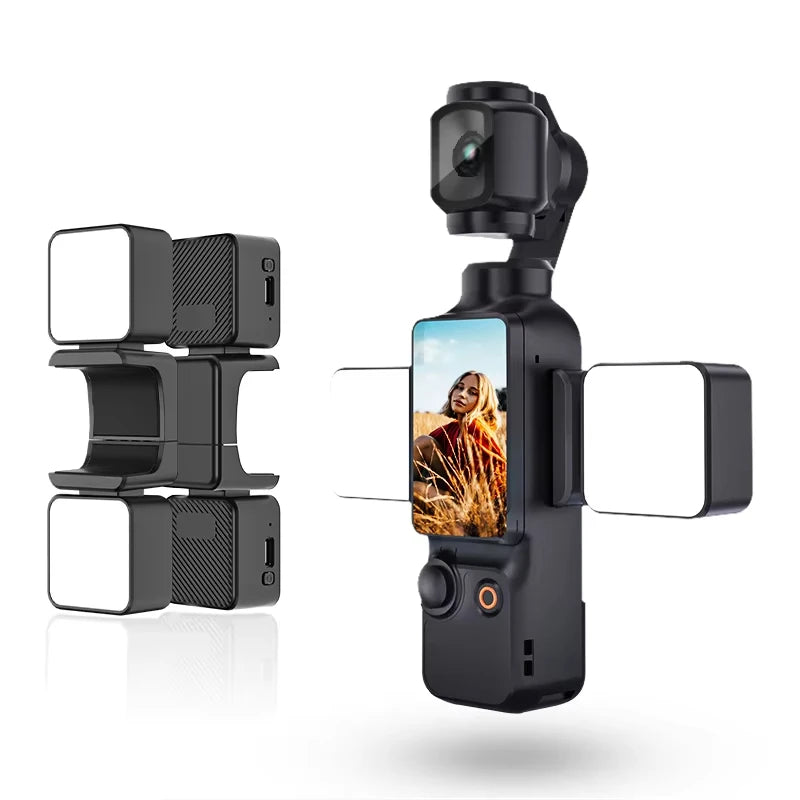 Handheld gimbal camera with a vertical screen, joystick, and two attachable magnetic LED square fill lights.