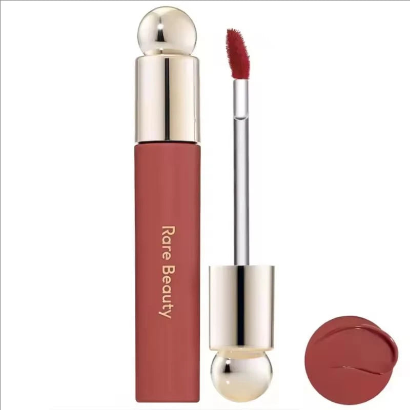 Rare Beauty Soft Pinch Tinted Lip Oil with doe-foot applicator, showing glossy mauve-pink pigment swatch.