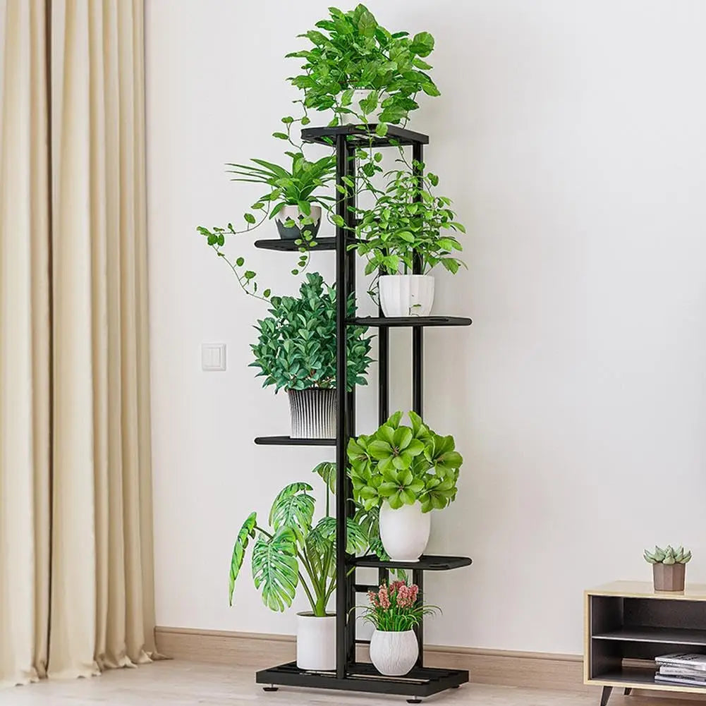 Multi-tier vintage plant display shelf with black metal frame, several potted plants