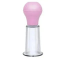 A facial massage vacuum cupping tool with a rounded pink rubber top and a clear, cylindrical plastic base.