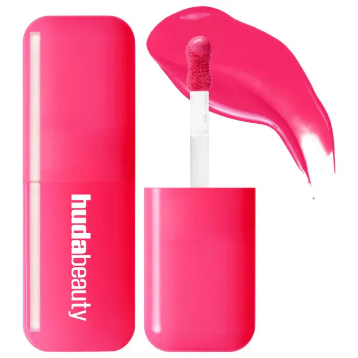 Huda Beauty hot pink hydrating lip and cheek tint stick with creamy texture and applicator swatch.
