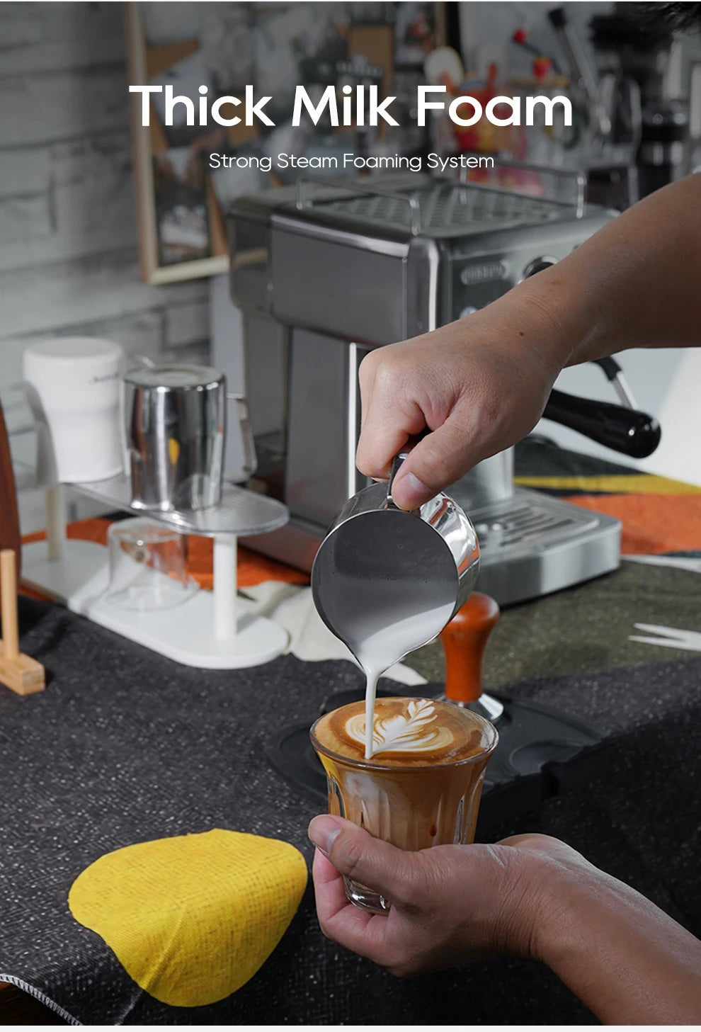 Stainless steel espresso machine pouring thick milk foam into a coffee glass for latte art.