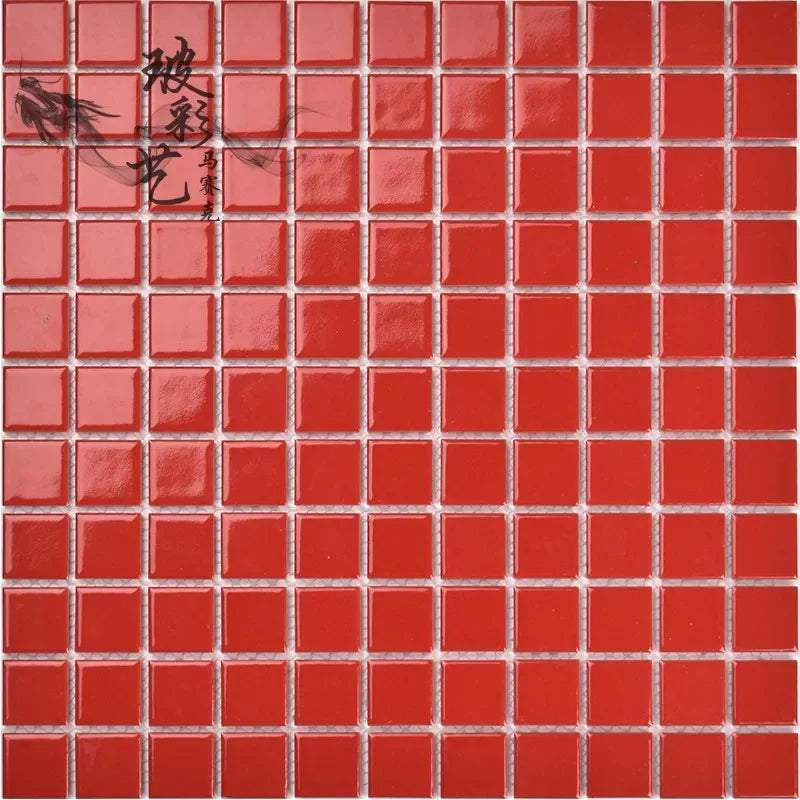 Red ceramic mosaic tile sheet with small square tiles and white grout lines