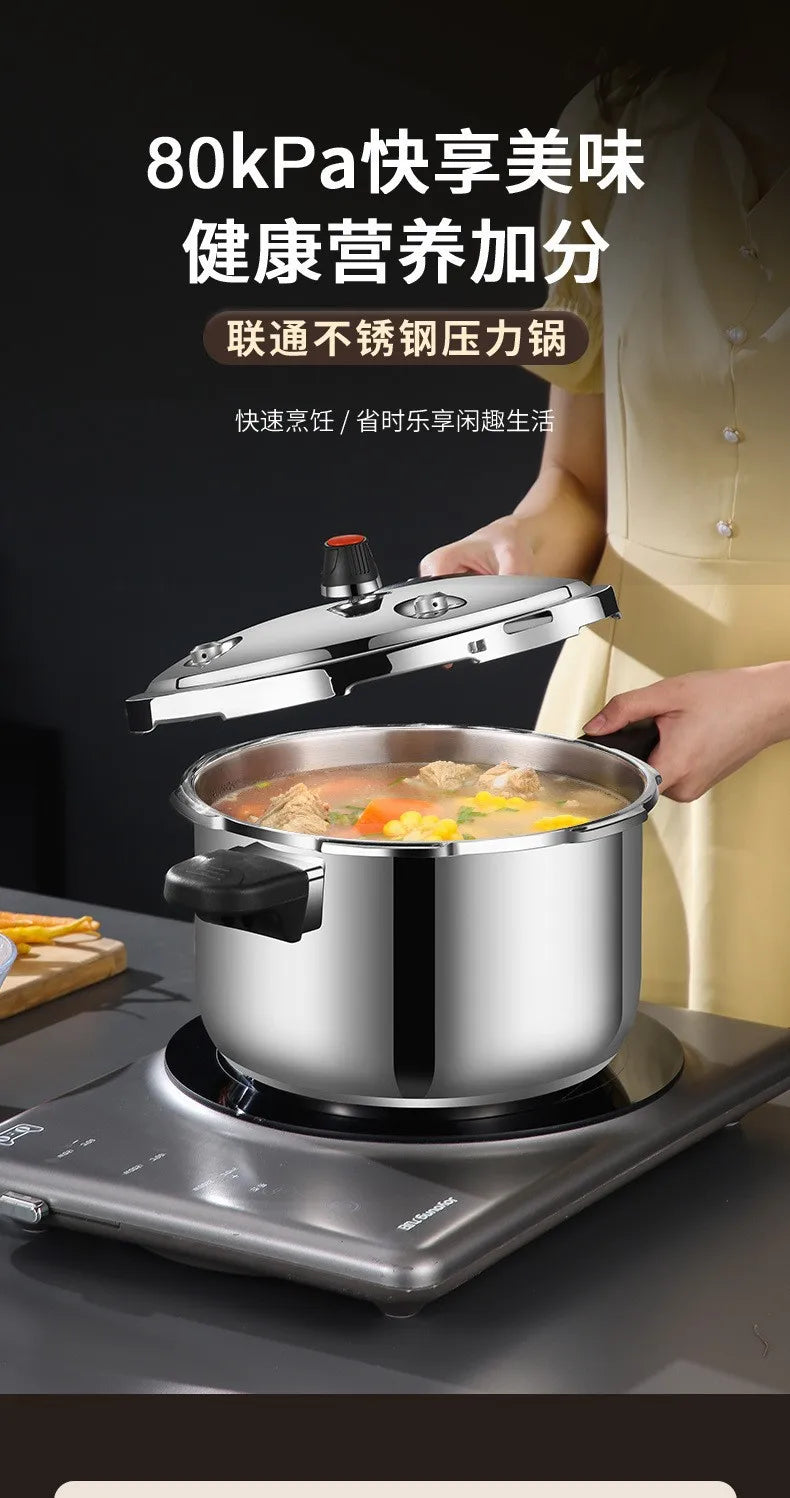Stainless steel pressure cooker with black side handles and vent knob, on countertop