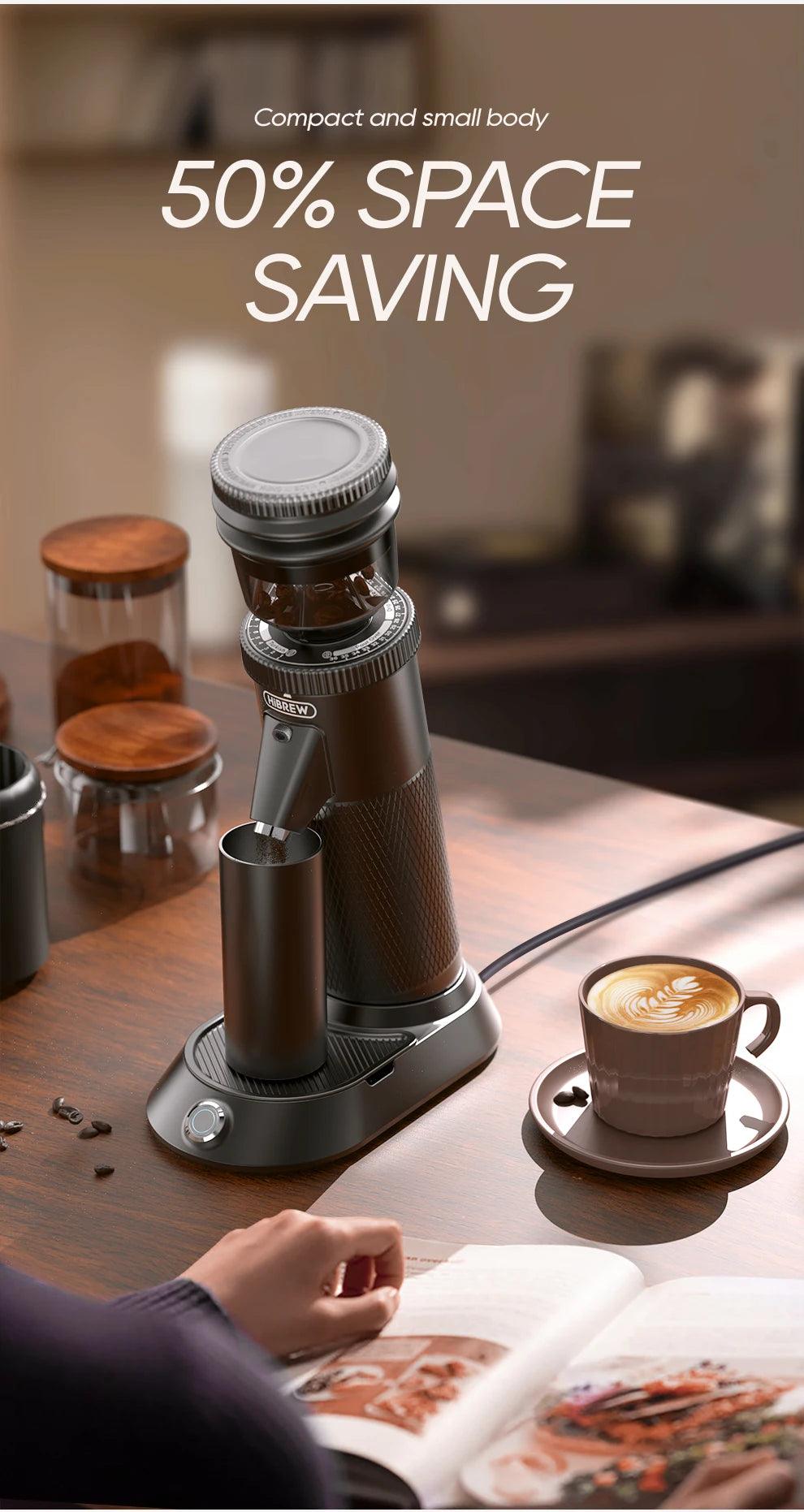 HiBREW compact black electric coffee grinder with vertical design, hopper, and metal dosing cup on a wooden table.