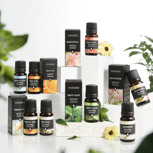 Yinsho amber glass aromatherapy essential oil bottles featuring Rose, Orange, Mint, and floral wellness scents.