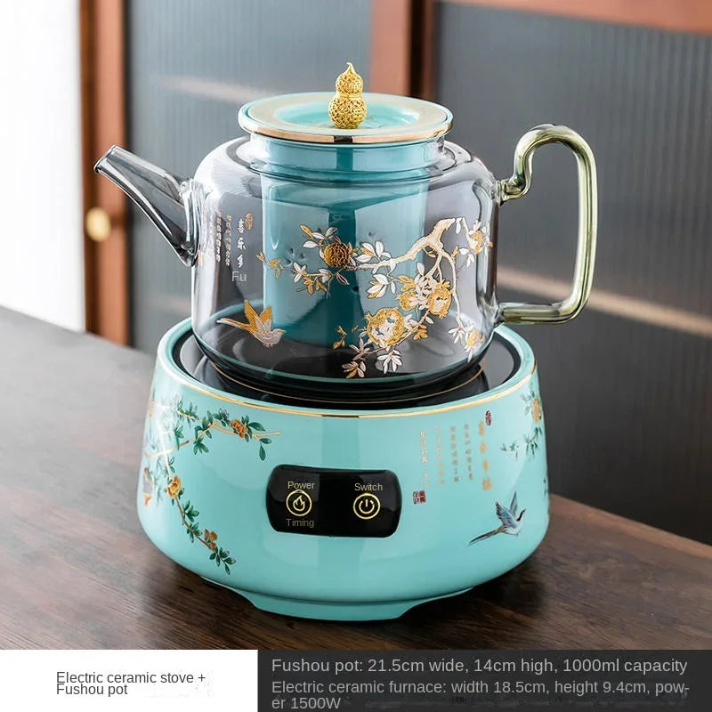 Teal ceramic electric tea stove with 1000ml glass Fushou pot, floral print, and 1500W heating element.