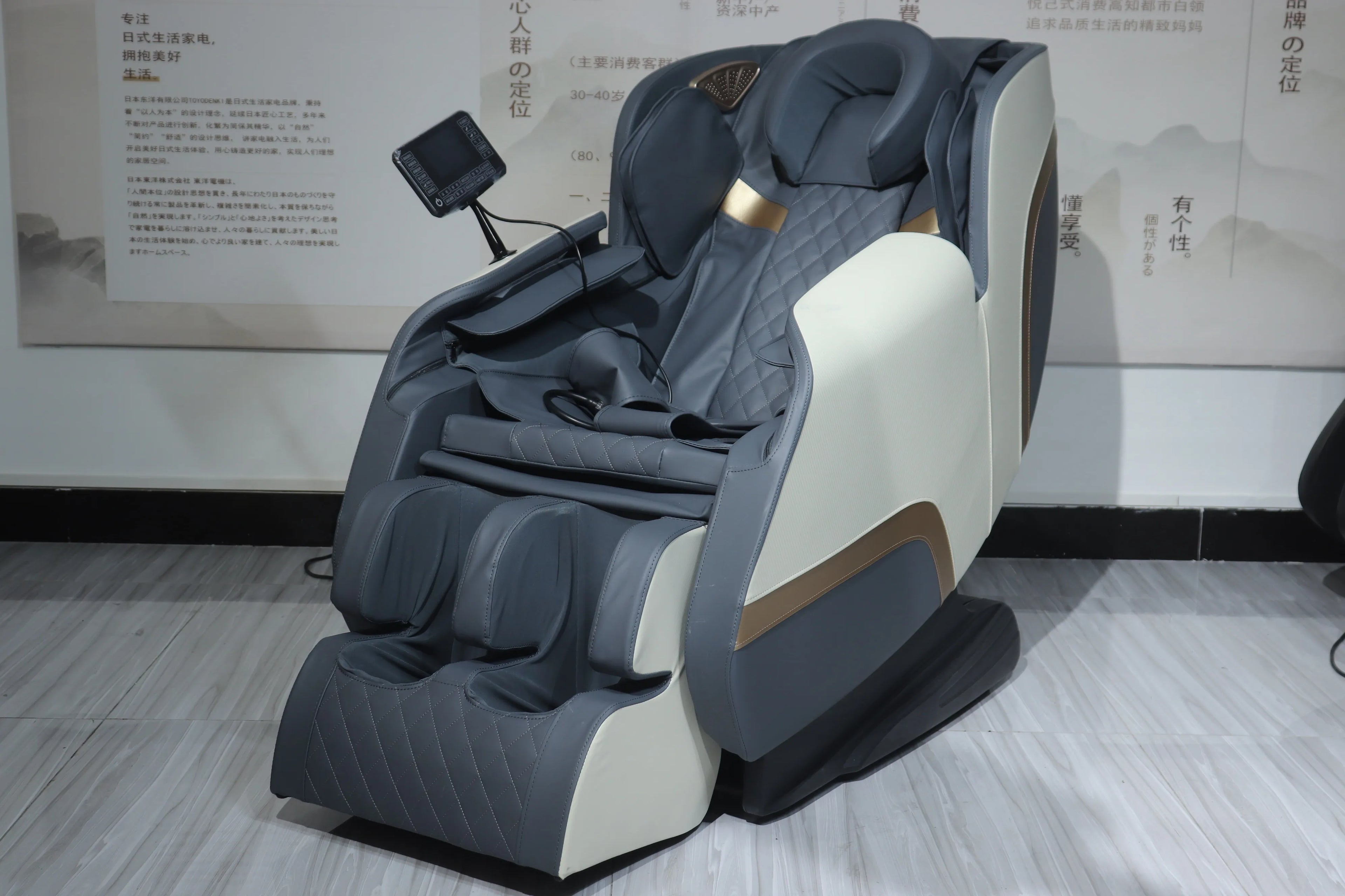 Gray shiatsu massage chair shown at an angle with recline position and side remote