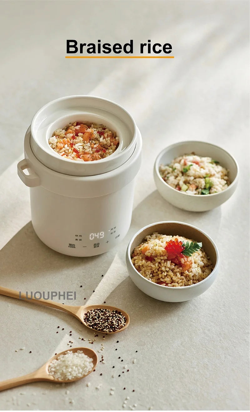White mini electric rice cooker with steamed rice inside and small serving bowls