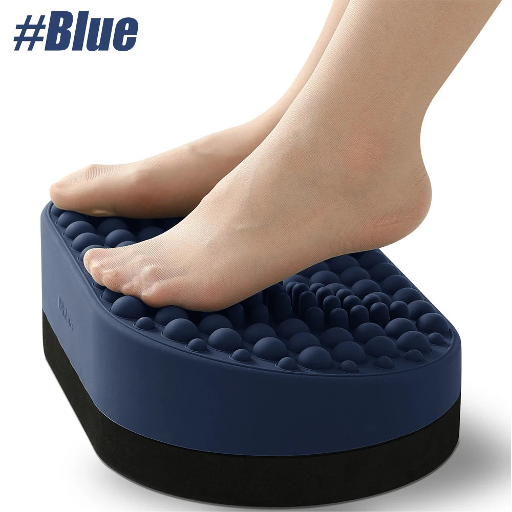 Blue silicone under desk foot rest with massage nodes, used by bare feet for office comfort and pain relief.