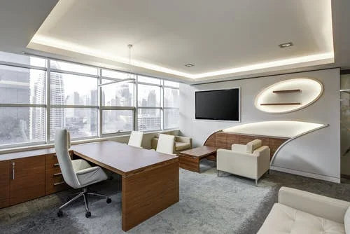 Modern office meeting room with seating and large windows