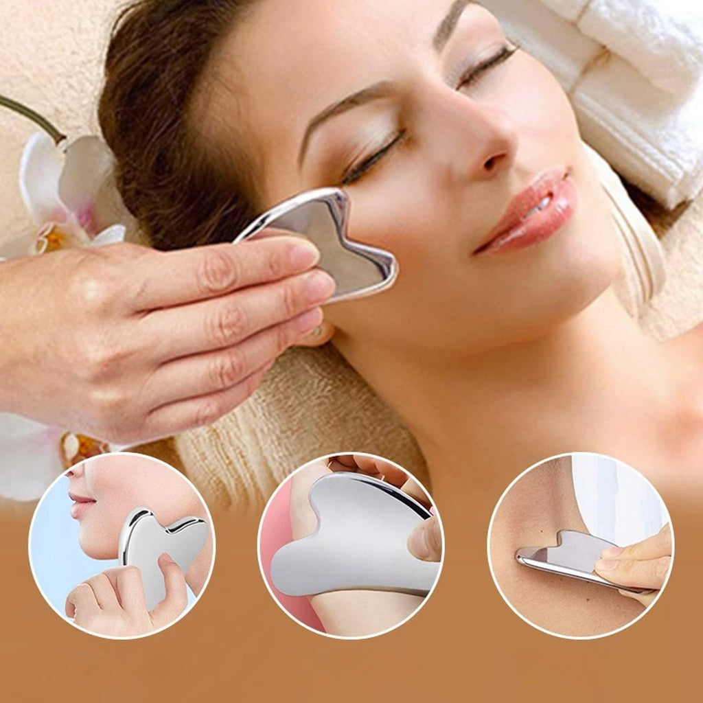 Silver heart-shaped stainless steel Gua Sha facial massage tool being used on face and neck skin.